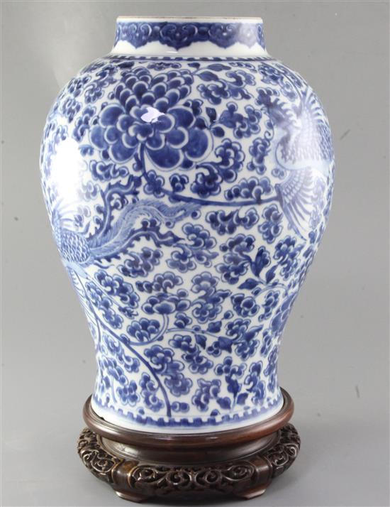 A Chinese blue and white phoenix and peony jar, Kangxi period, height 36cm, rosewood cover and stand